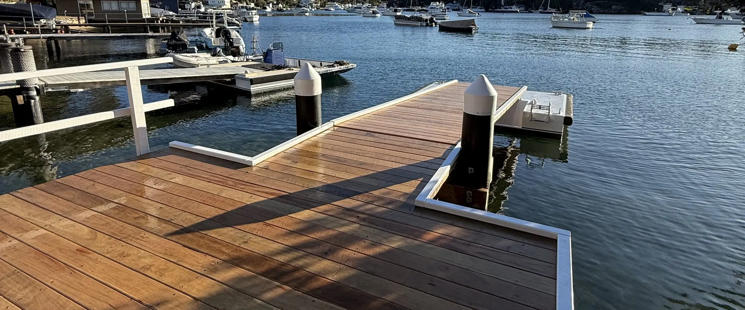 A newly decked jetty and pontoon with the moored fleet behind