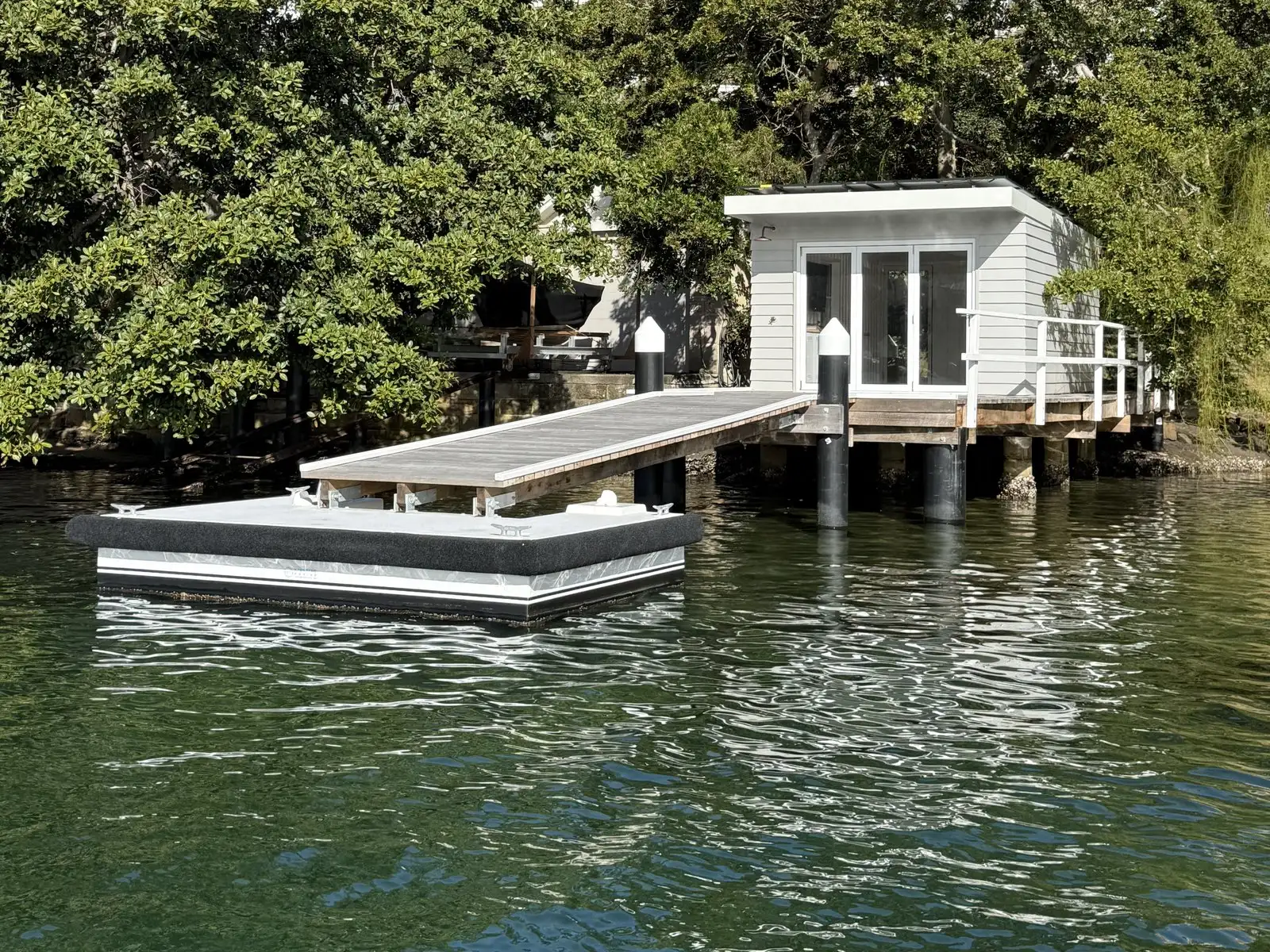 Pontoon and jetty in front of a finished waterfront boat shed