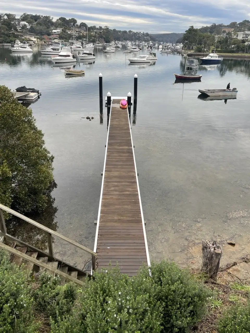 A long narrow jetty running out from the bank to the moorings