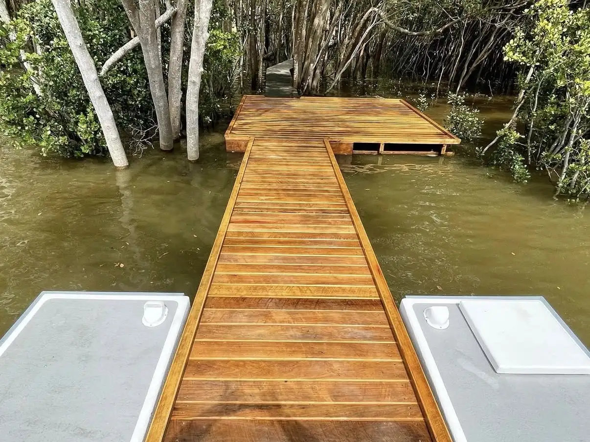 Hardwood jetty and landing built out through mangroves on a high tide