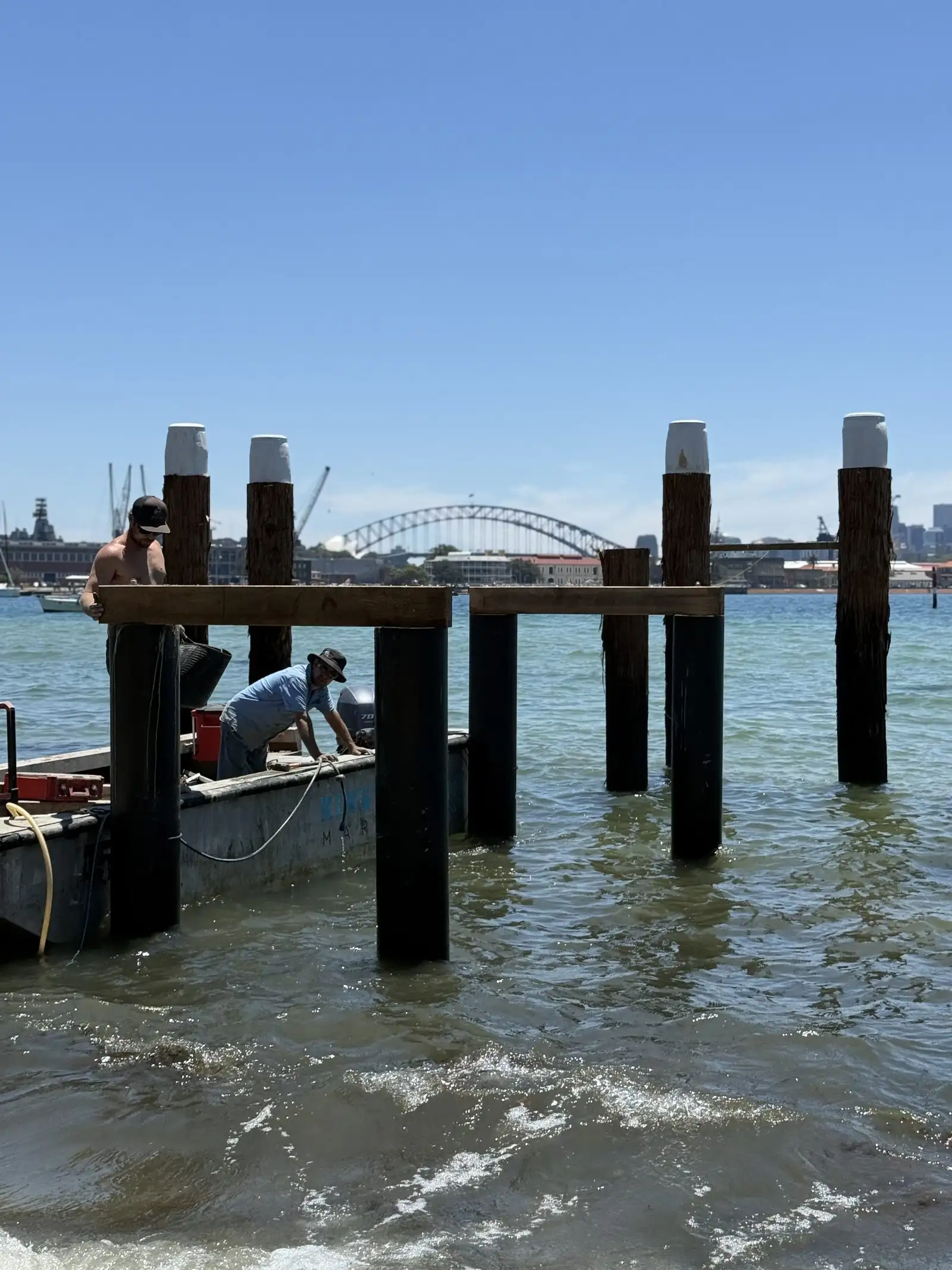 Capped piles standing in the water before the deck goes on