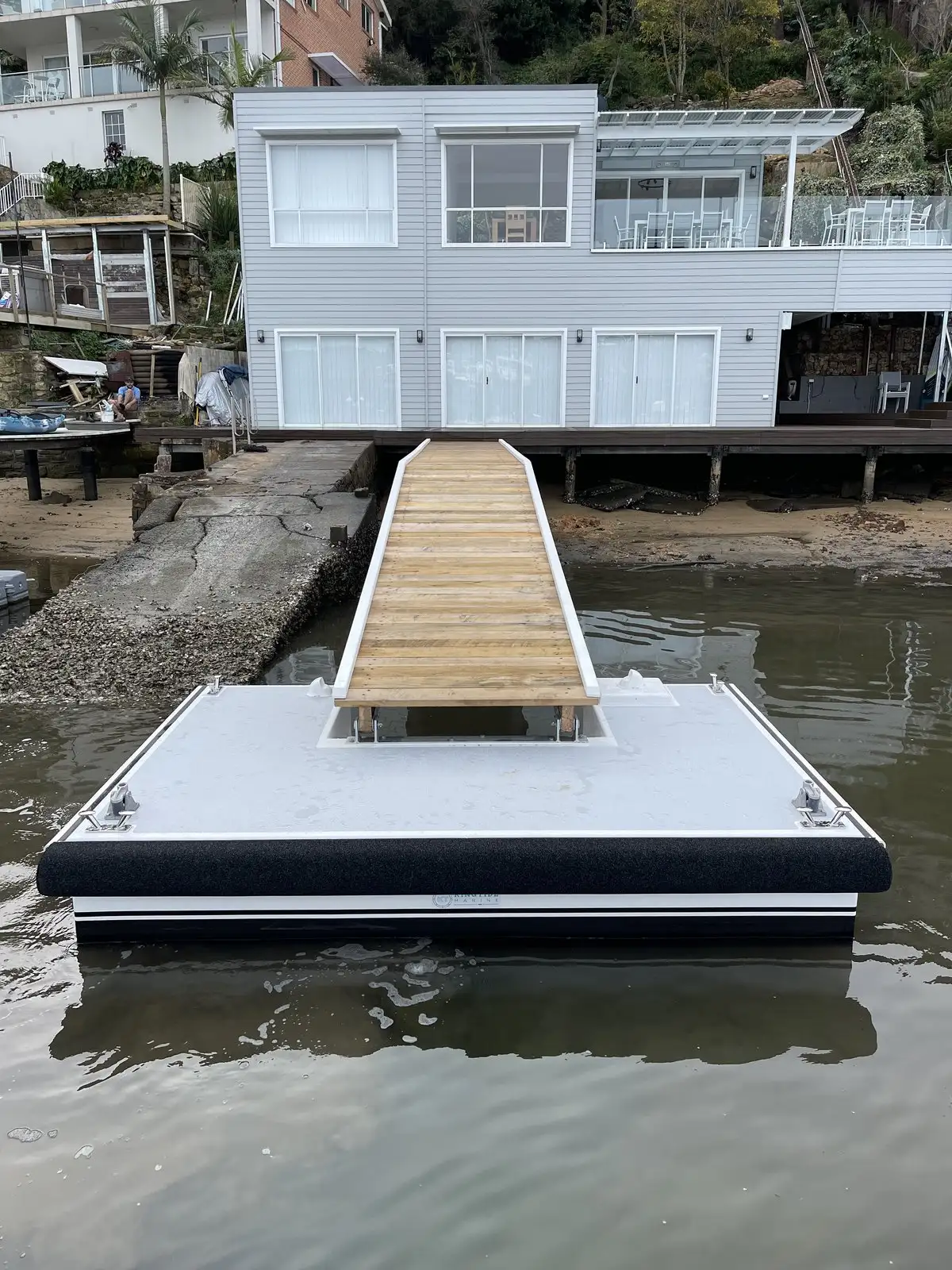 Pontoon and ramp at a waterfront house, sitting level with the tide