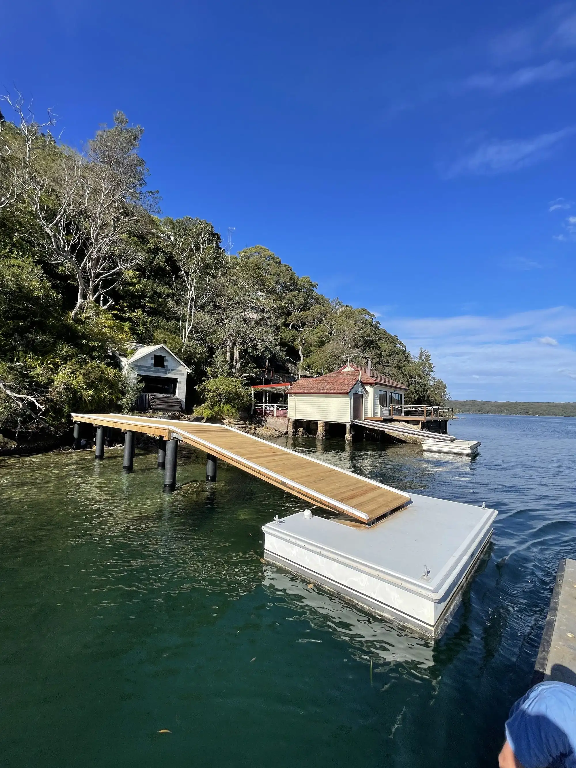 Floating pontoon with hardwood decking moored off a jetty