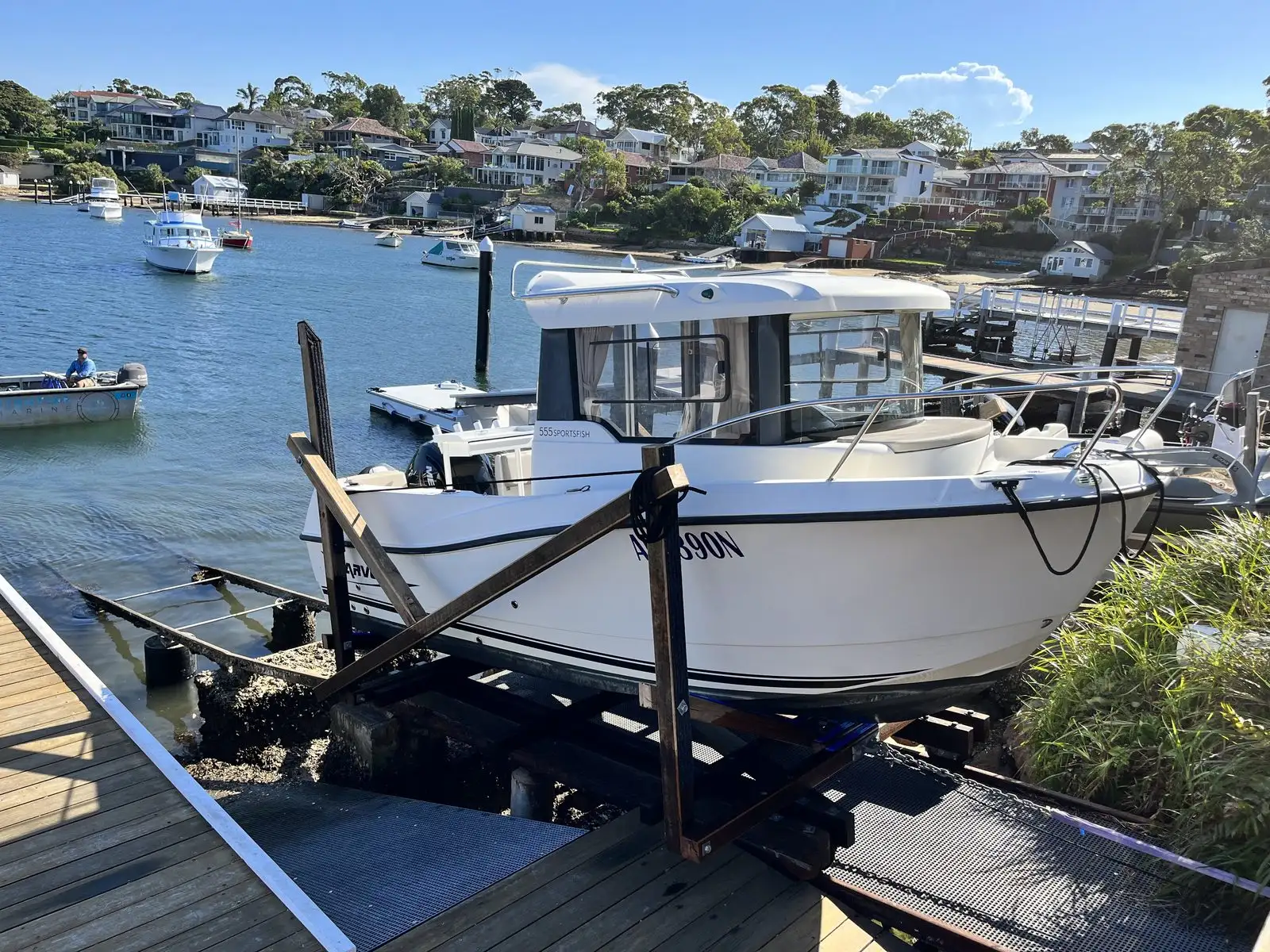 Sportsfish hull resting on a Kingtide Marine cradle built to fit it, with timber bracing packed to the shape of the hull