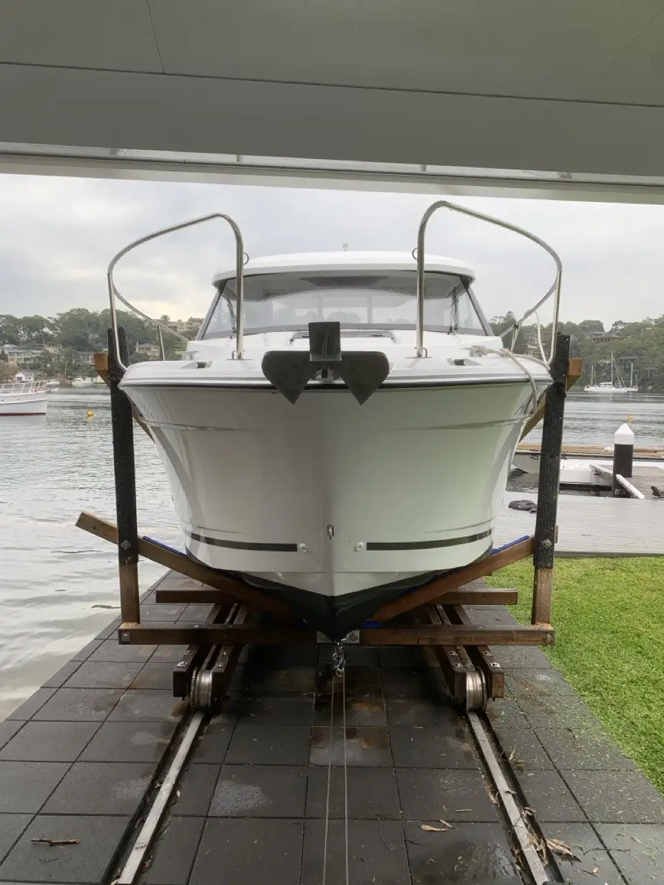 A boat drawn up the rails into its boat shed