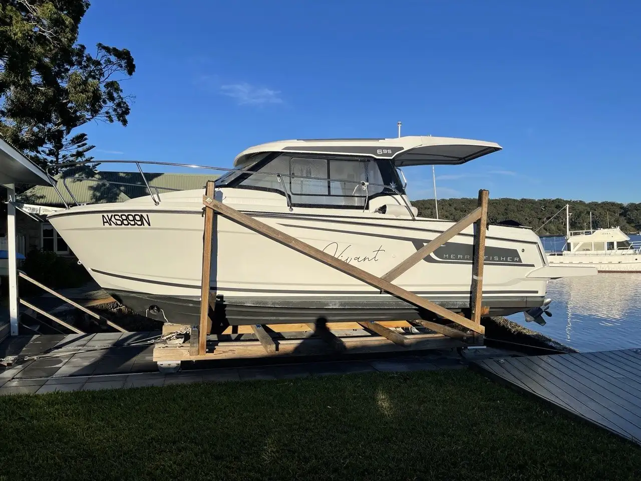 A cruiser sitting on a Kingtide Marine timber cradle at the top of a waterfront slipway
