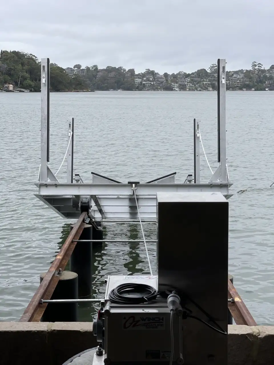 An empty cradle and winch sitting on the slipway rails