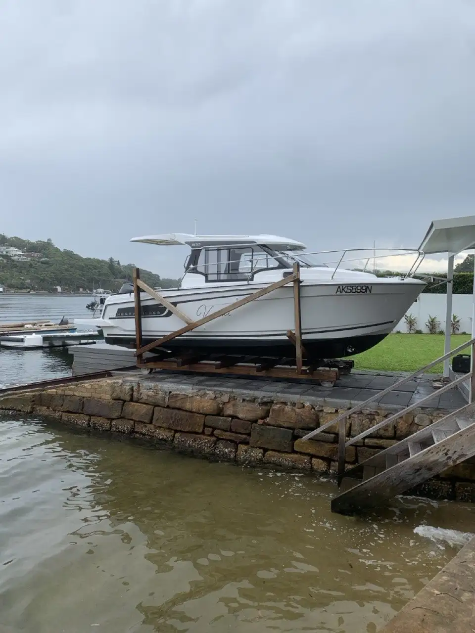 A boat on its cradle above a sandstone seawall