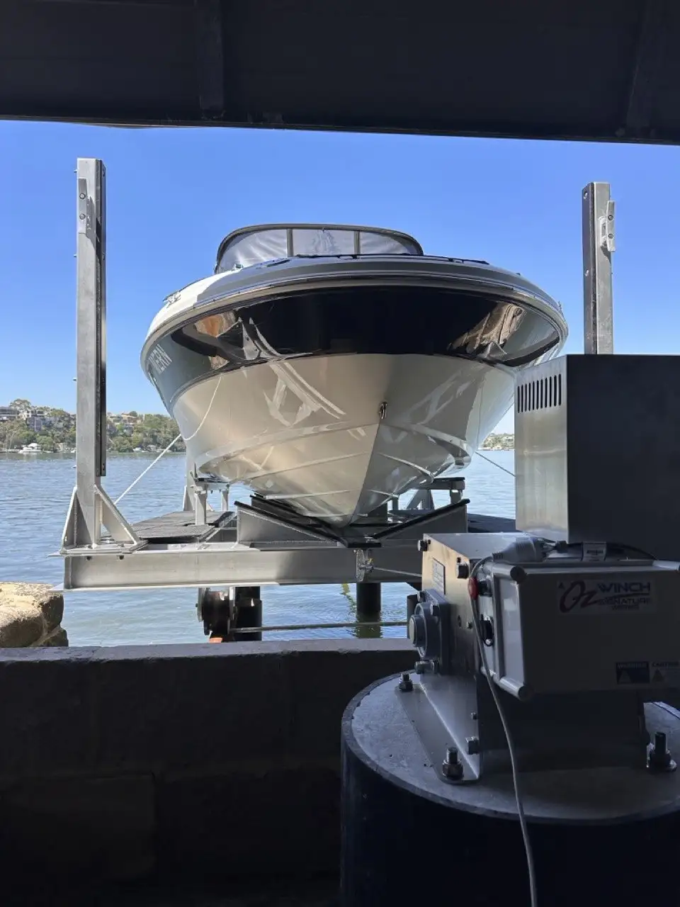 A boat on its cradle inside the shed, with the winch gear alongside