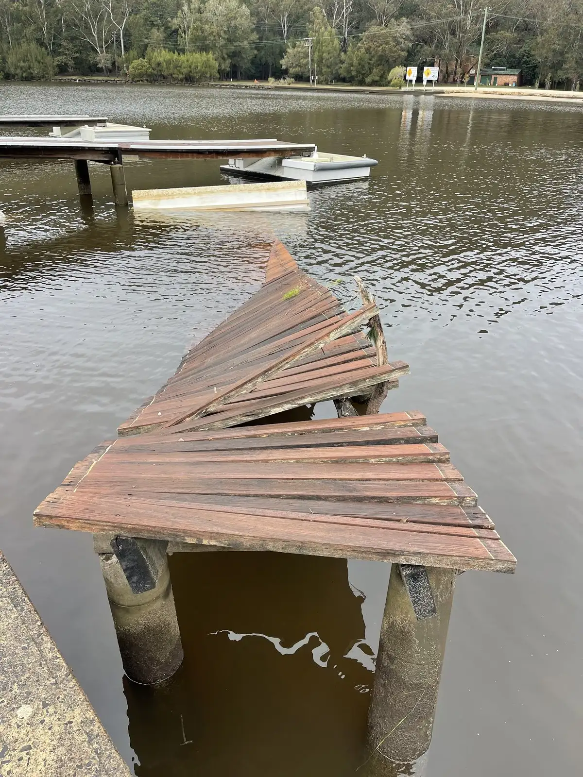 Jetty decking torn loose and fanned out over the water